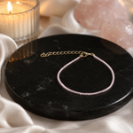 Rudvya Rose Quartz Anklet product photo on black stone display